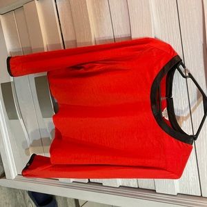 Bright red long sleeve blouse with black leather